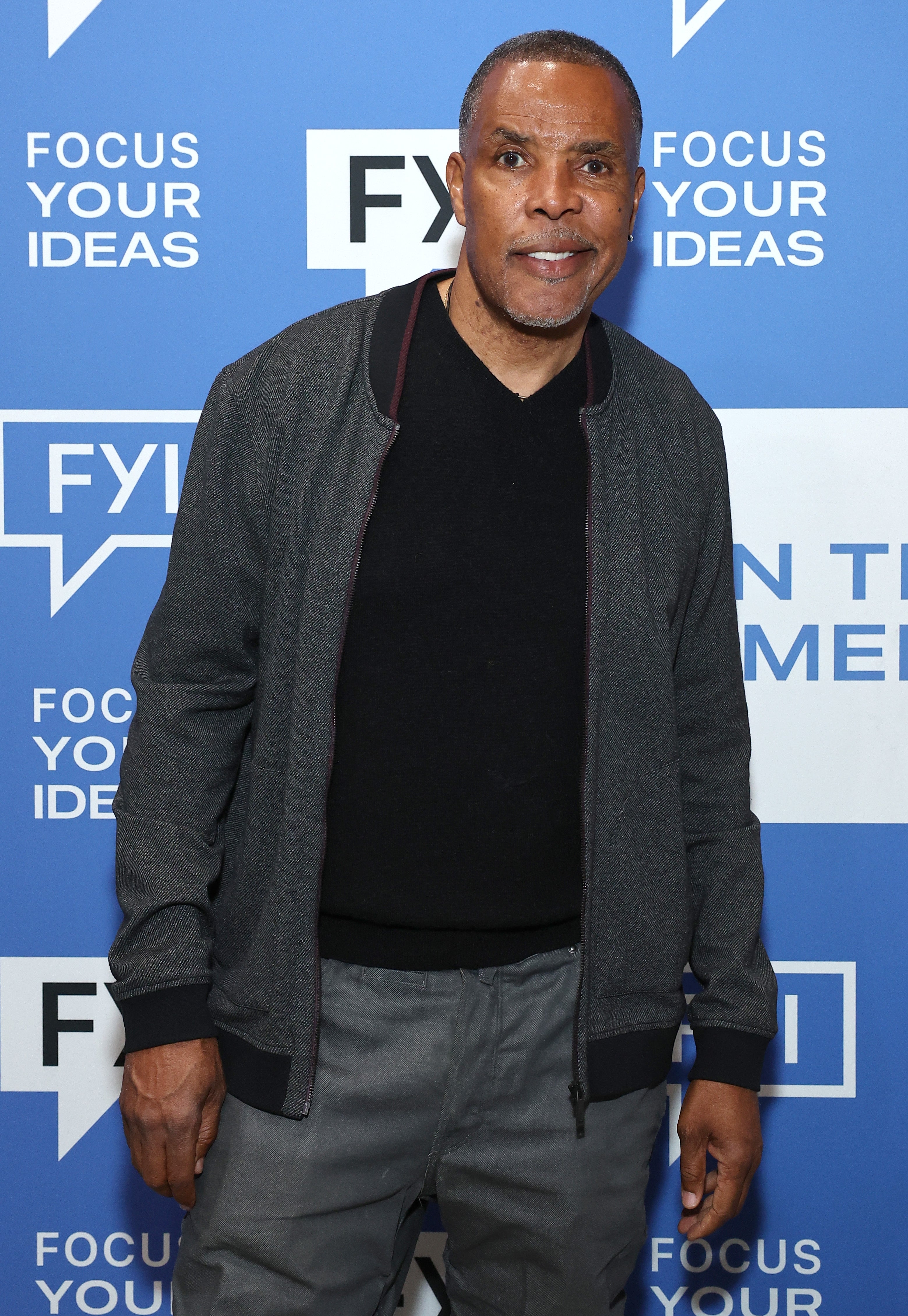 A man on the red carpet wearing a casual outfit