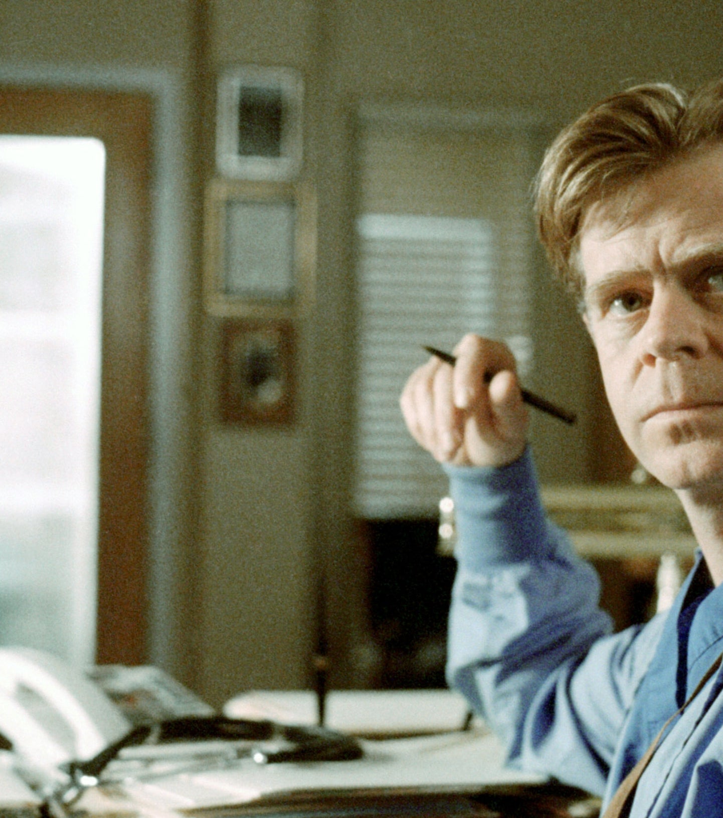 A man wearing scrubs in an medical office setting