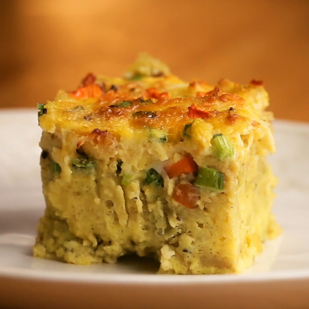 Slice of savory cornbread casserole with vegetables, featuring a golden crust, served on a plate