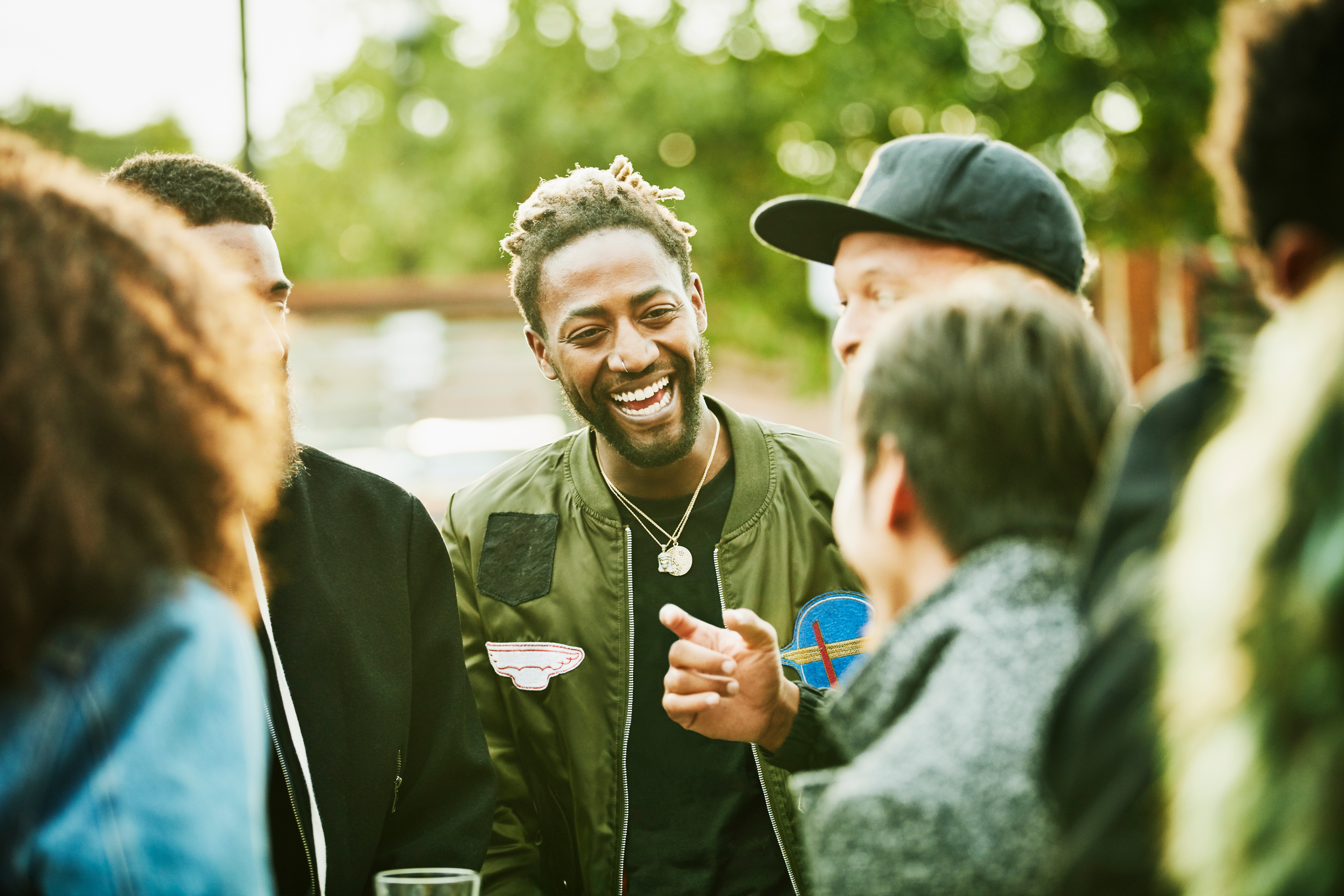 Group of radical   socializing outdoors, smiling and engaging successful  conversation, creating a lively ambiance  successful  a parkland  oregon  outdoor setting