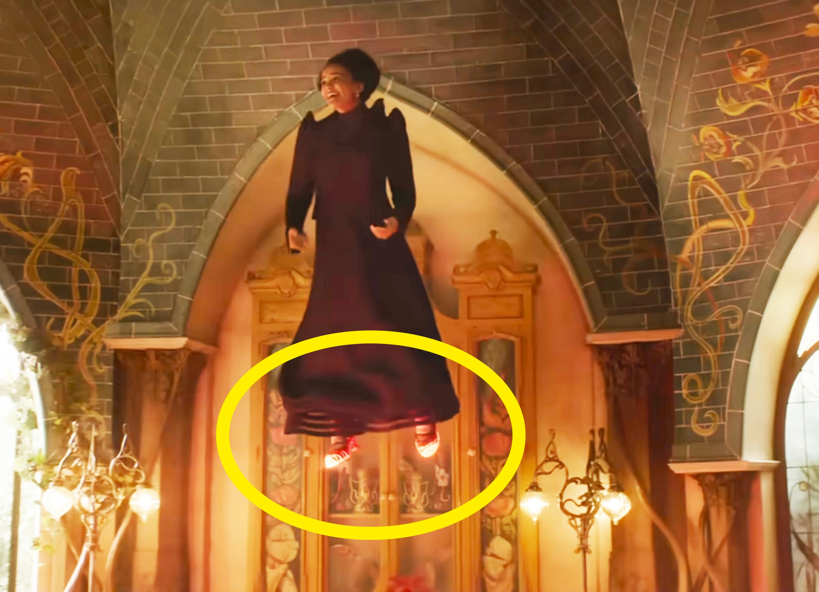 A character wearing a long dark dress is levitating in an ornate room with arched ceilings and glowing lanterns