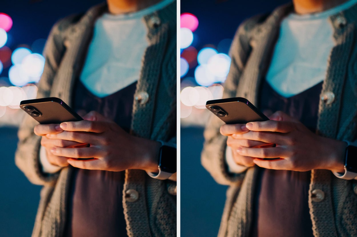 Person in cozy knit sweater using a smartphone outdoors, with blurred city lights in the background