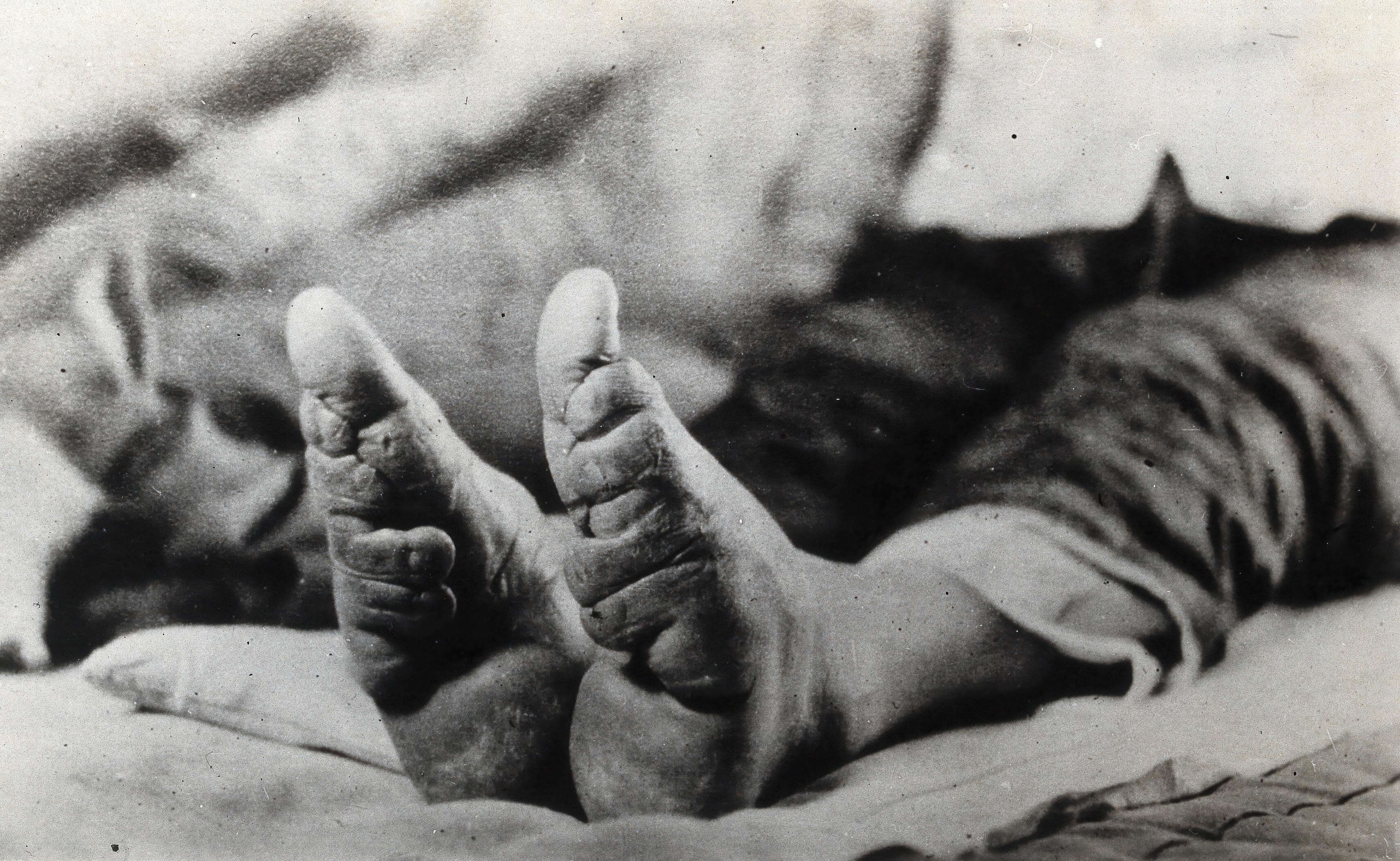 Person lying down   with bare feet visible, resting connected  a surface. The representation  focuses connected  the soles of their feet