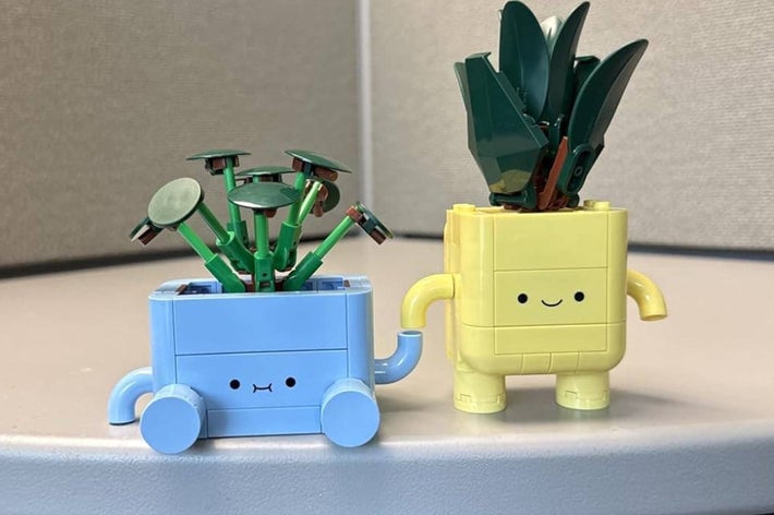 Otter figure holding roll of tape; mini dodo night-light placed on desk