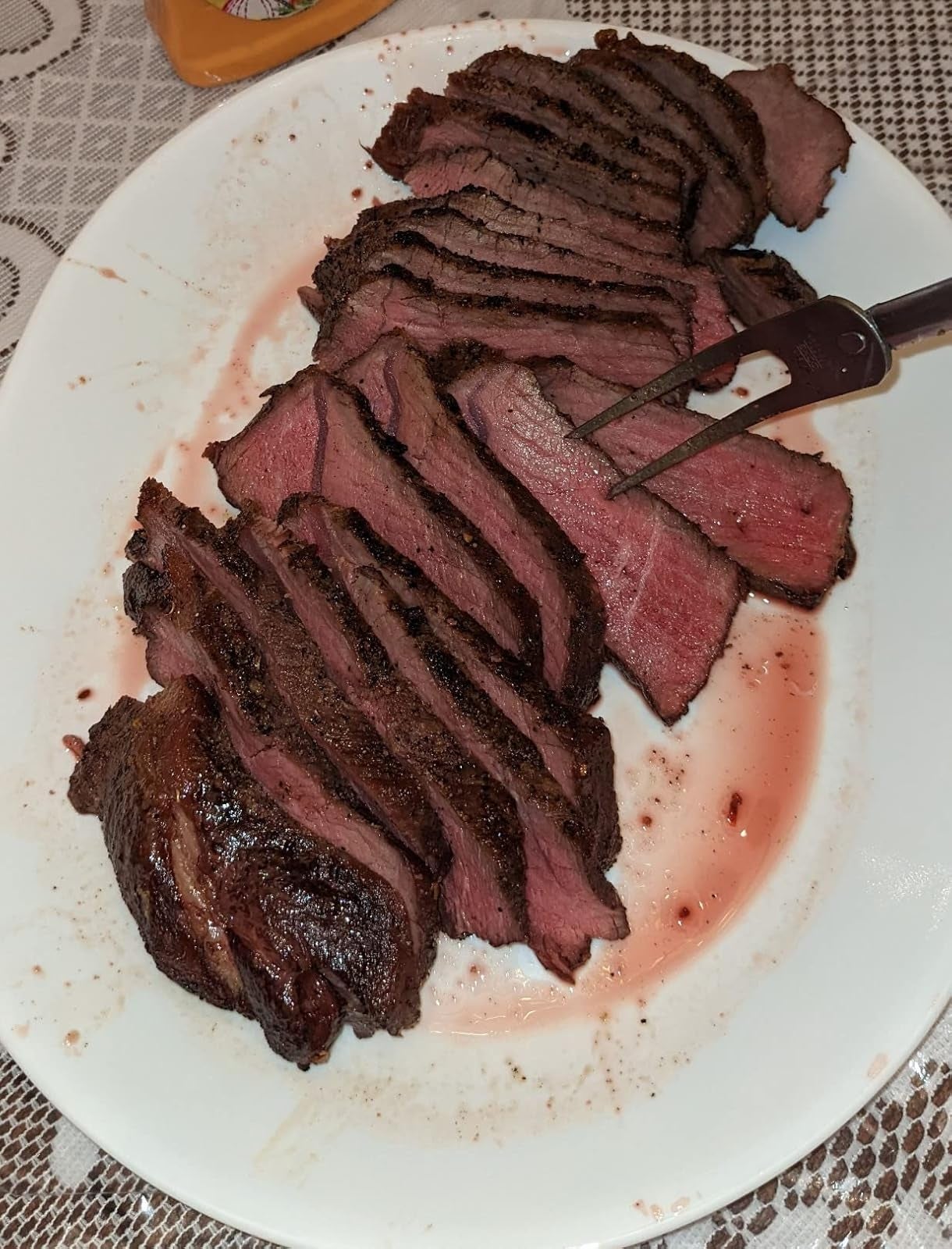 Sliced steak connected  a achromatic  sheet  with a fork, highlighting a juicy, cooked-to-perfection appearance