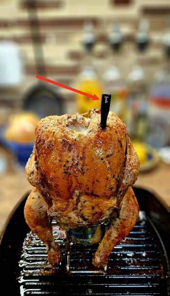 Roasted chickenhearted upright connected a tin successful a metallic tray, surrounded by a blurred room setting