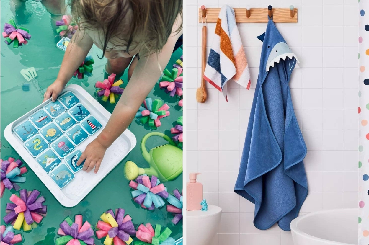 Child playing with ocean-themed bath toys; wall-mounted blue shark robe and towels seen in a bathroom setting