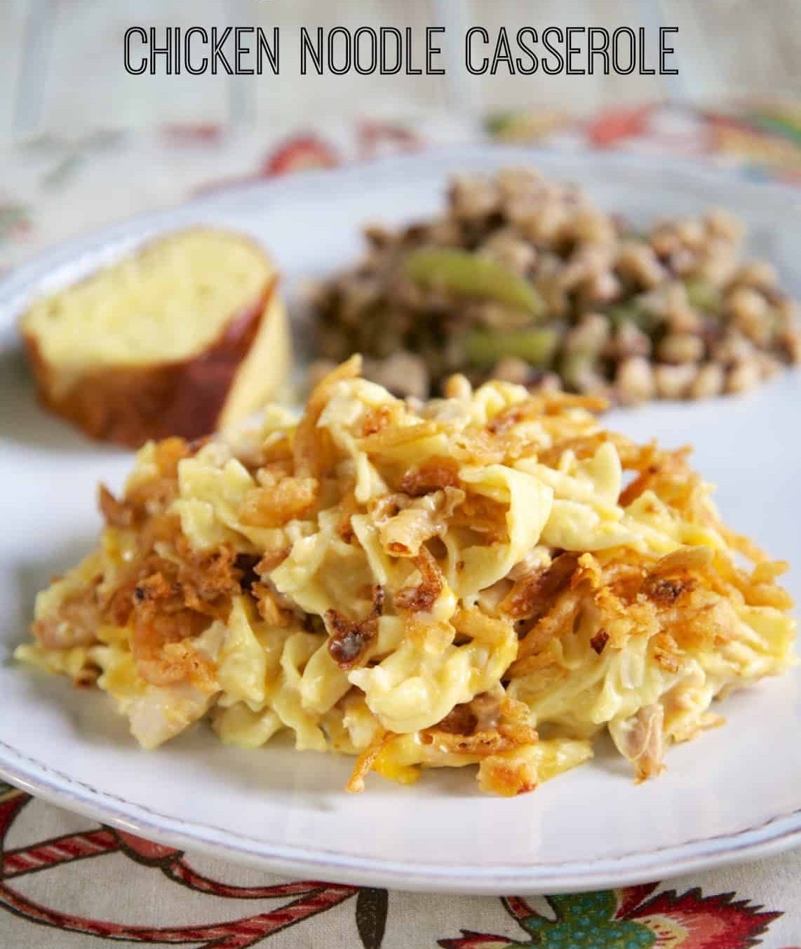 Plate with French onion chicken noodle casserole, a bread slice, and a side of peas and onions. Text reads "French Onion Chicken Noodle Casserole."