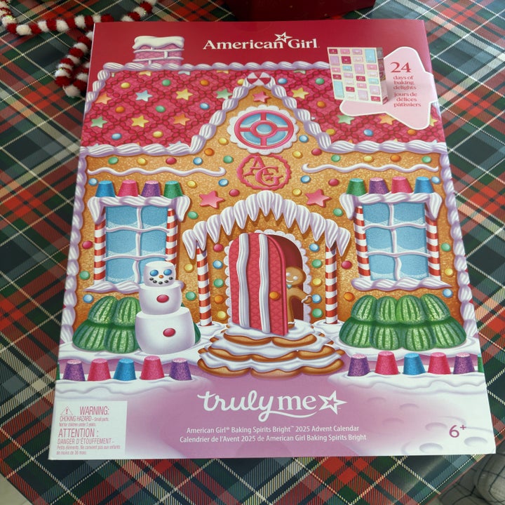 American Girl 2025 Advent calendar featuring a gingerbread house design with candy decorations and a snowman figure