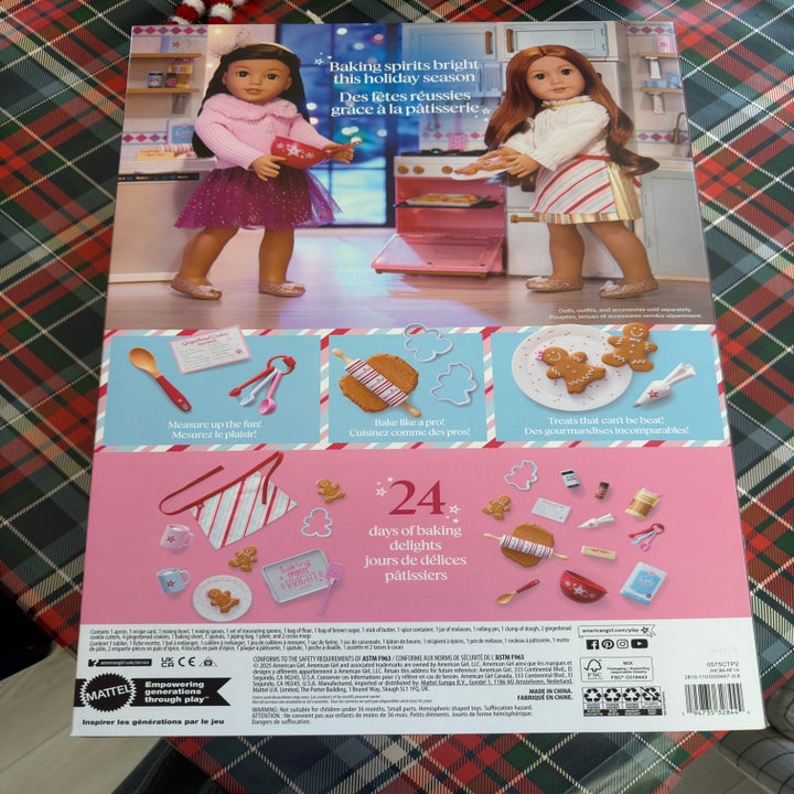 Back of a bakery-themed doll set box featuring two dolls in aprons with baking accessories and text about holiday baking fun