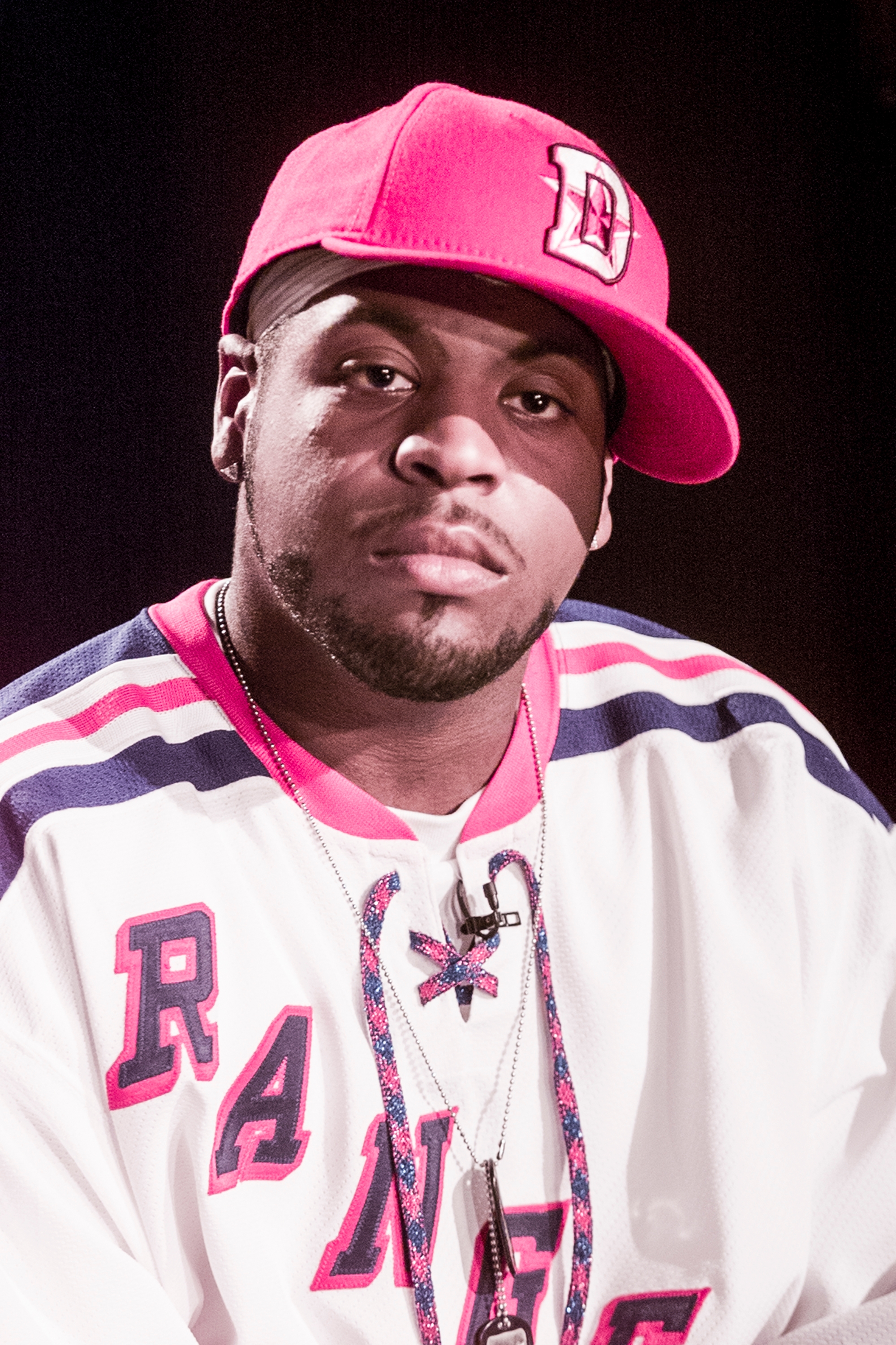 En person som har på seg en sportstrøye og en caps med 