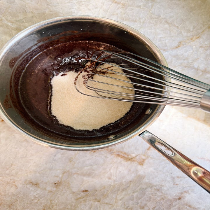 Whisk blending cocoa powder and sugar in a saucepan