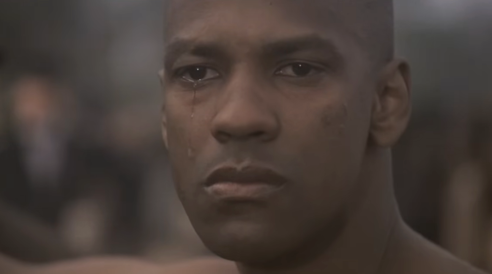 A idiosyncratic   with a superior   look  and tears disposable   connected  their face, looking into the distance