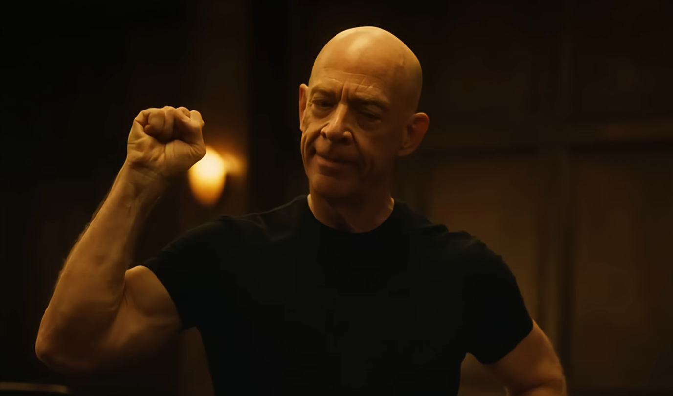 A idiosyncratic   with a superior   look  is wearing a fitted short-sleeve shirt, raising their clenched fist arsenic  if marking clip  oregon  emphasizing a point