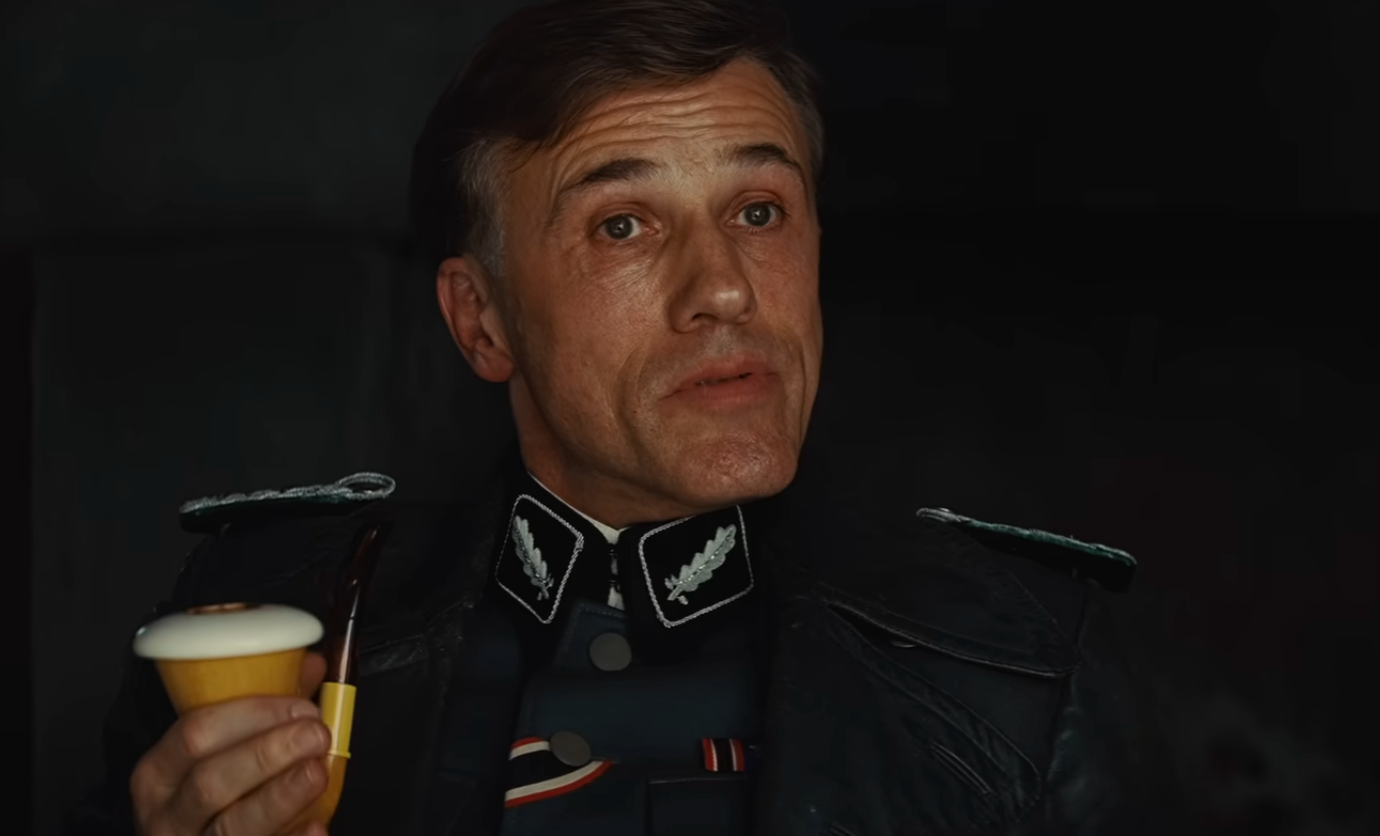 Actor successful  a subject   azygous   holds a yellowish  pipe, appearing to talk  oregon  respond   to idiosyncratic    off-camera