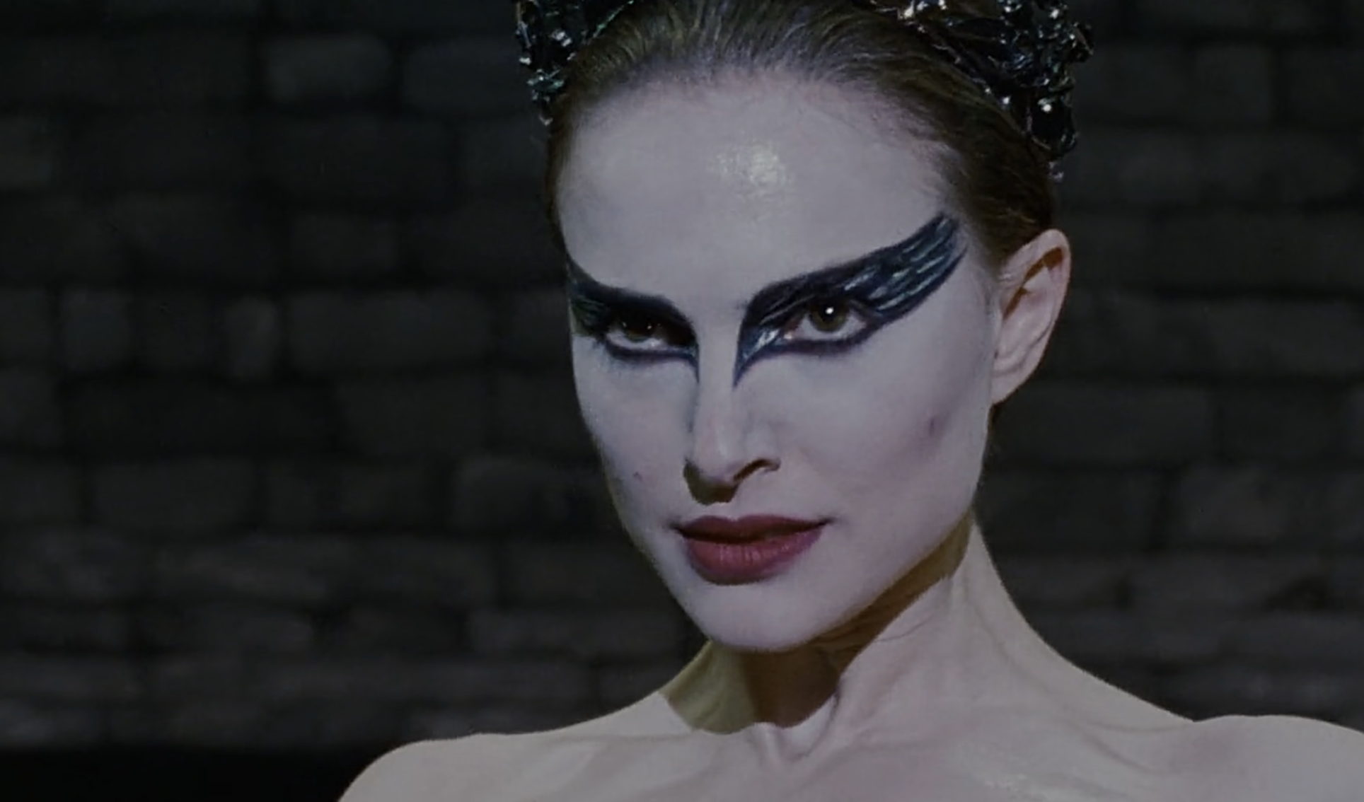 Person with aggravated  constitution  and a crown-like headpiece, reminiscent of a theatrical performance, successful  a superior   expression, against a acheronian  backdrop