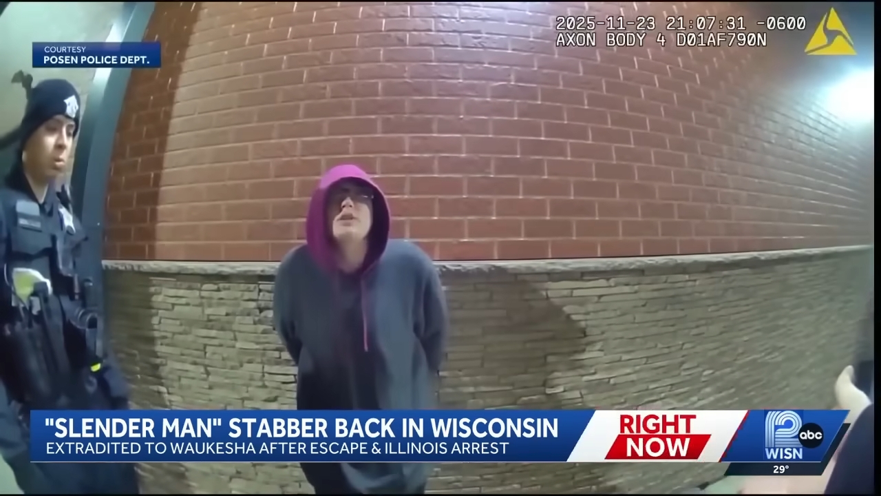 A person in a hoodie stands in handcuffs against a brick wall, accompanied by police. News headline mentions a &quot;Slender Man&quot; case extradition to Wisconsin