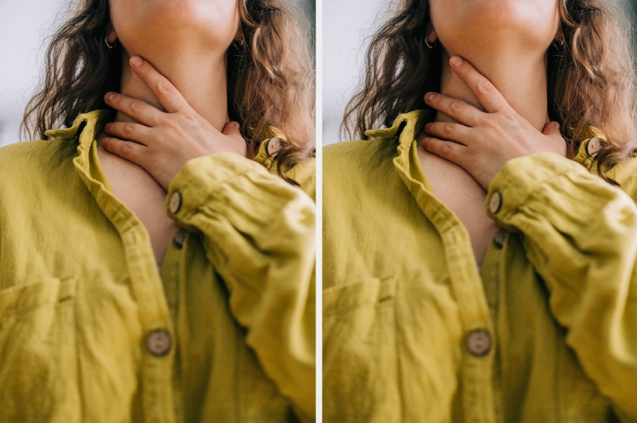 Person with curly hair touching their neck, wearing a loose jacket with large buttons, suggesting a focus on health or wellness