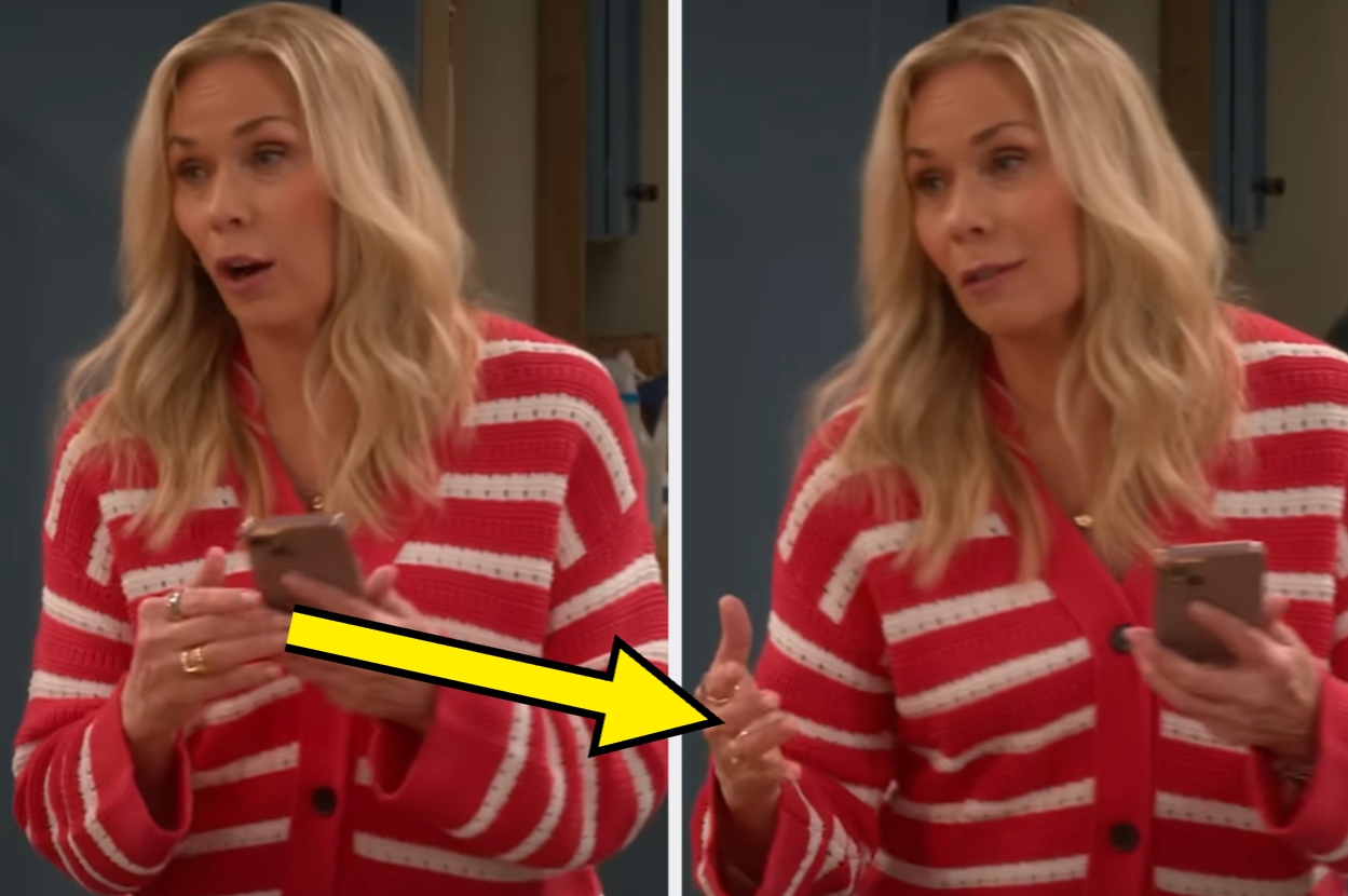 Person in a striped cardigan holding a smartphone, gesturing expressively with one hand