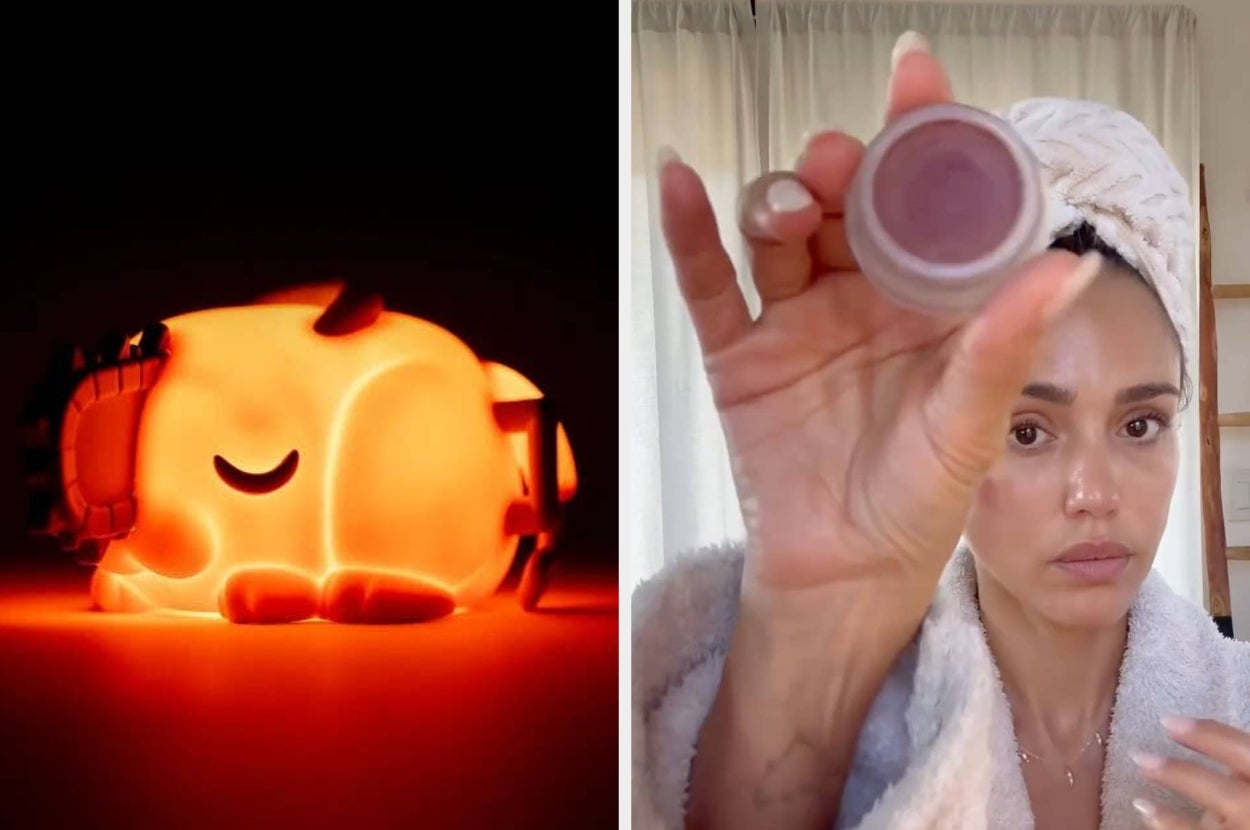 A person in a robe with a towel turban holds a pot of cream. A sleeping cartoon character lamp is lit beside them
