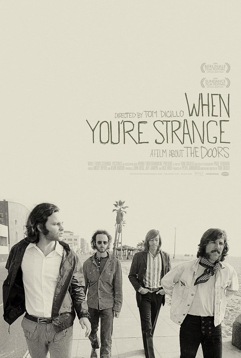 Cartel de "When You're Strange". Foto en blanco y negro de cuatro hombres caminando en la calle. Texto sobre el documental de The Doors