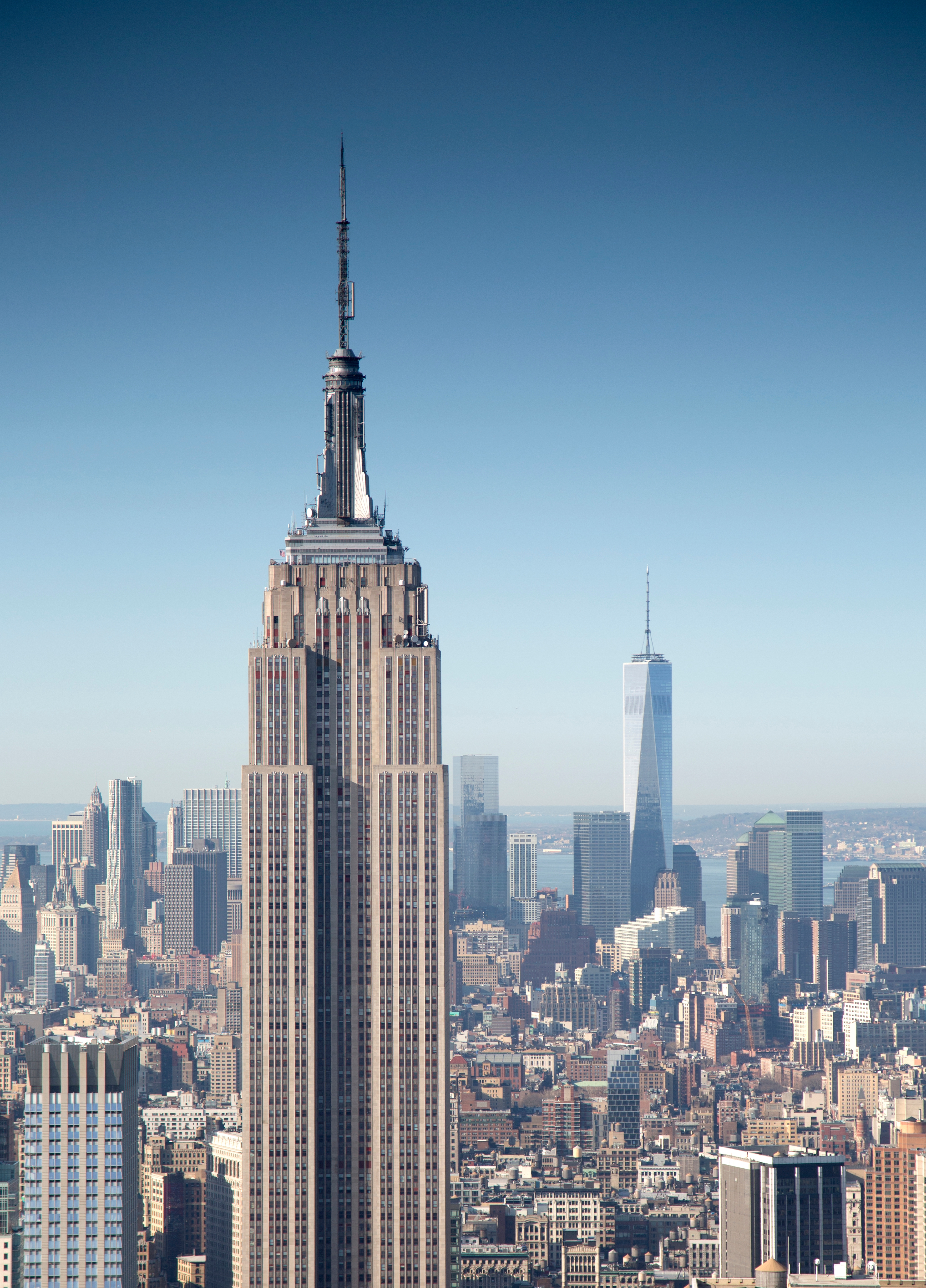 View of New York City skyline with the Empire State Building successful the foreground and One World Trade Center successful the background