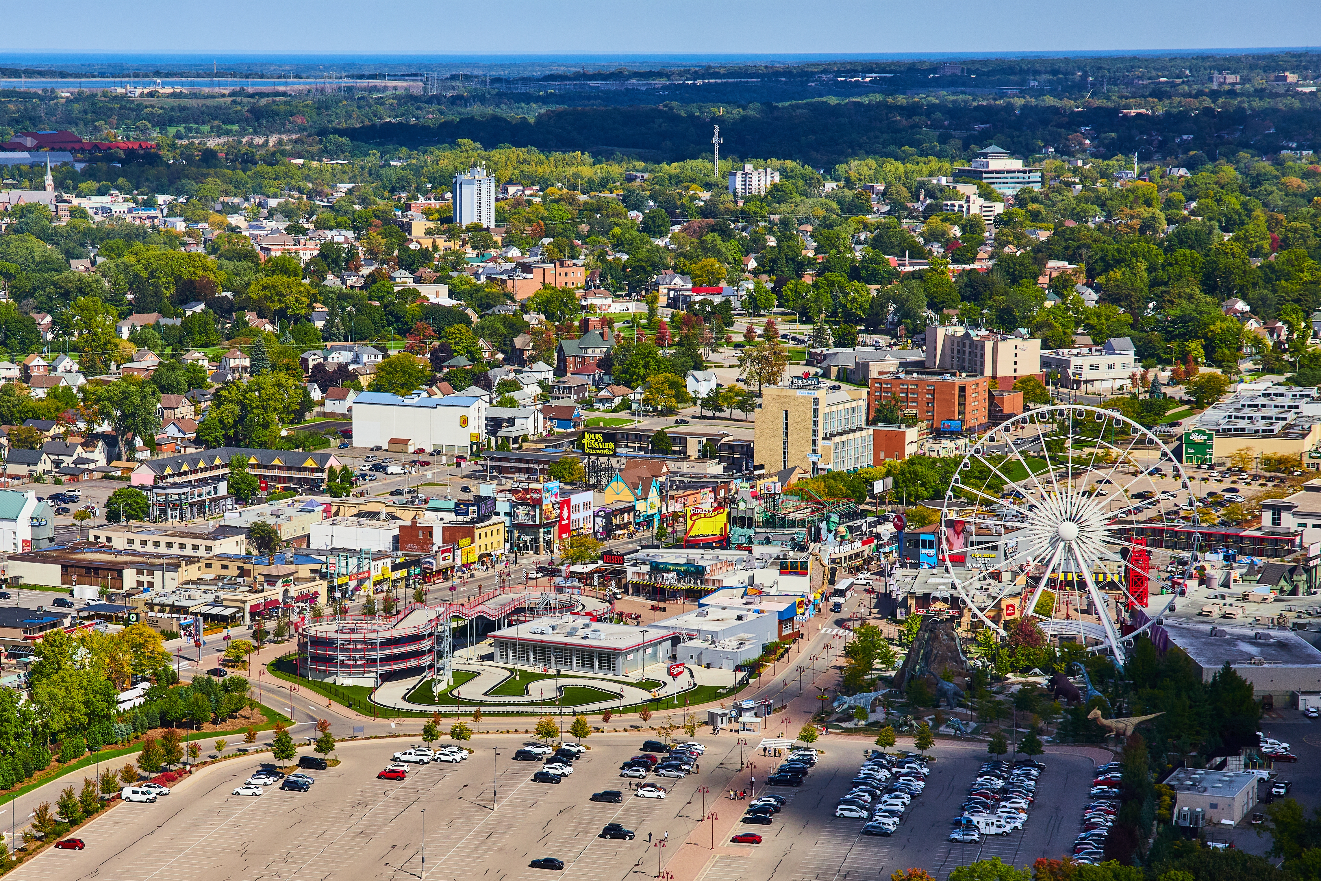 Aerial presumption of a engaged Niagara Falls with a ample Ferris wheel, surrounded by a municipality and greenery