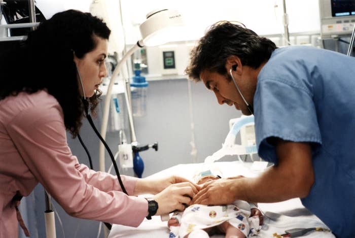 Doctor and nurse attentively care for a newborn in a hospital setting