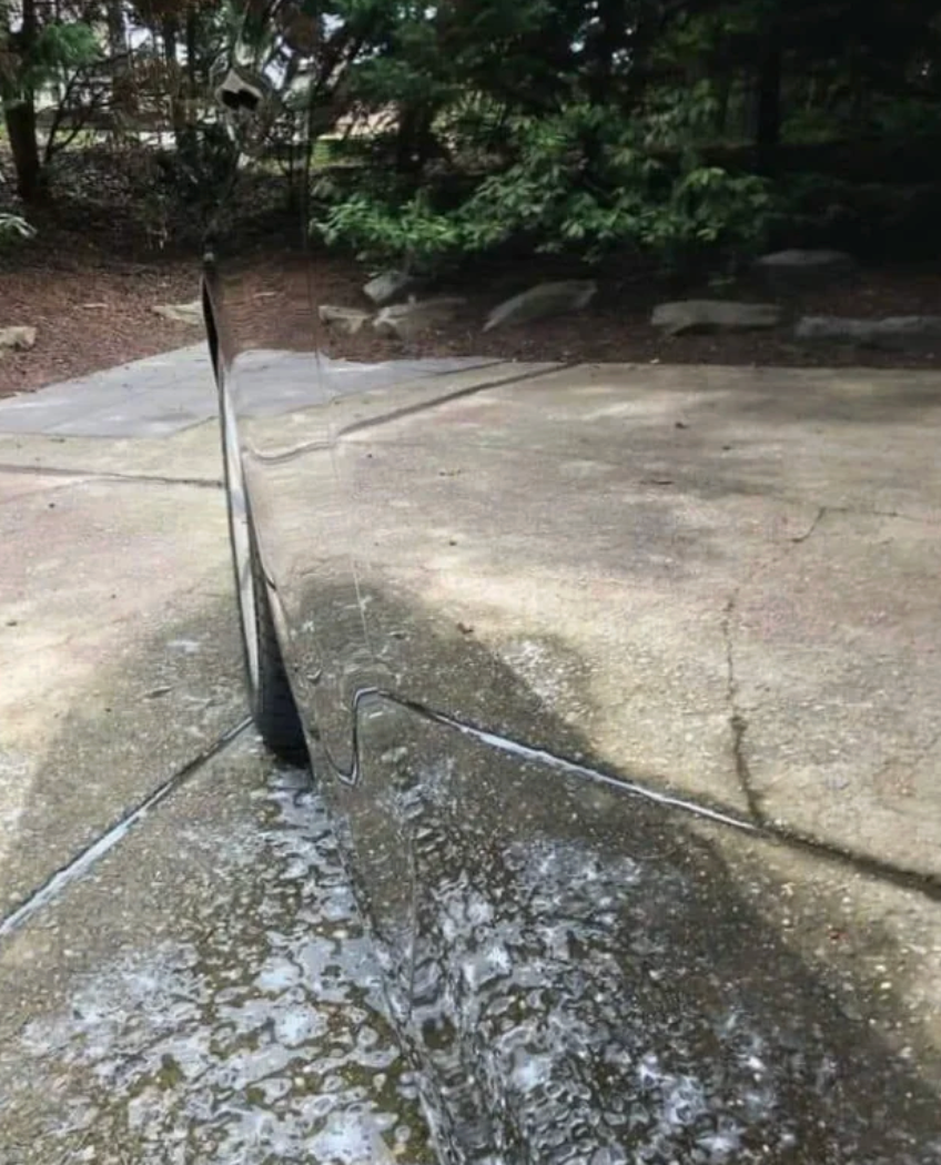 Optical illusion of a bladed  obstruction   casting a shadow, blending with the pathway and creating a mirrored effect