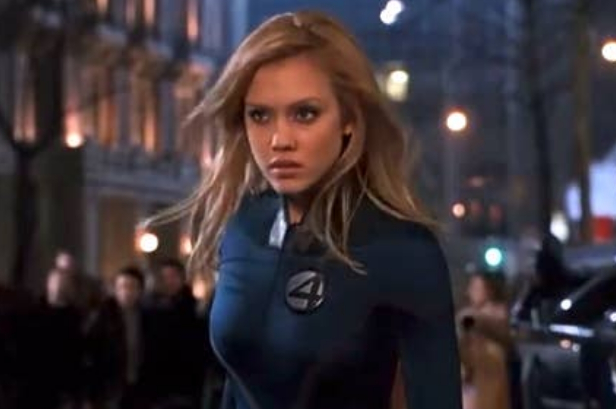 Person in superhero costume walking confidently on a city street at night