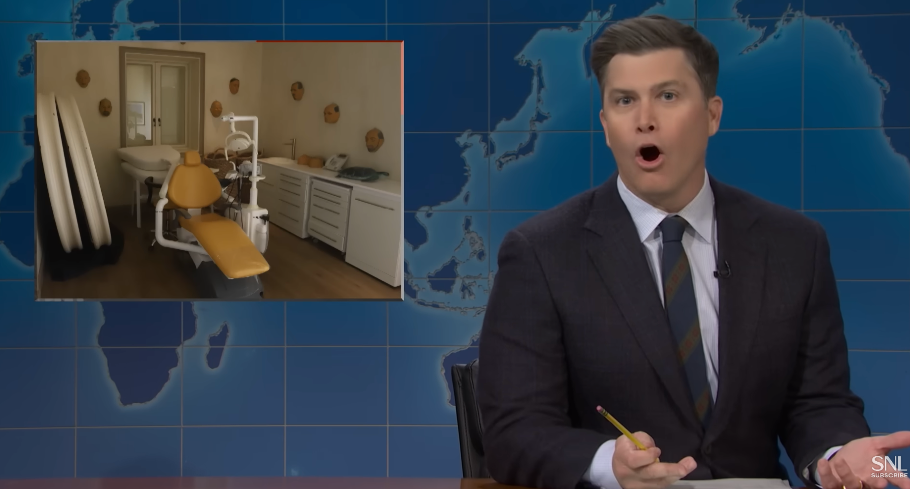 Colin Jost in a suit hosting a news segment appears surprised. An image of a dentist chair is displayed on a screen behind them