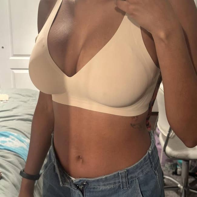 Person wearing a seamless underwire bra and high-waisted jeans