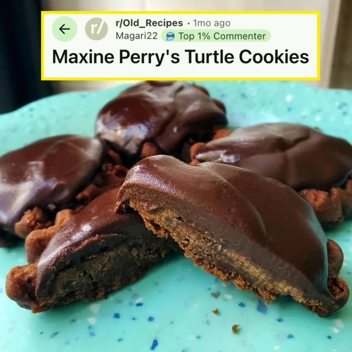 Chocolate-covered cookies on a plate, one cookie is broken in half to show its dense, rich interior