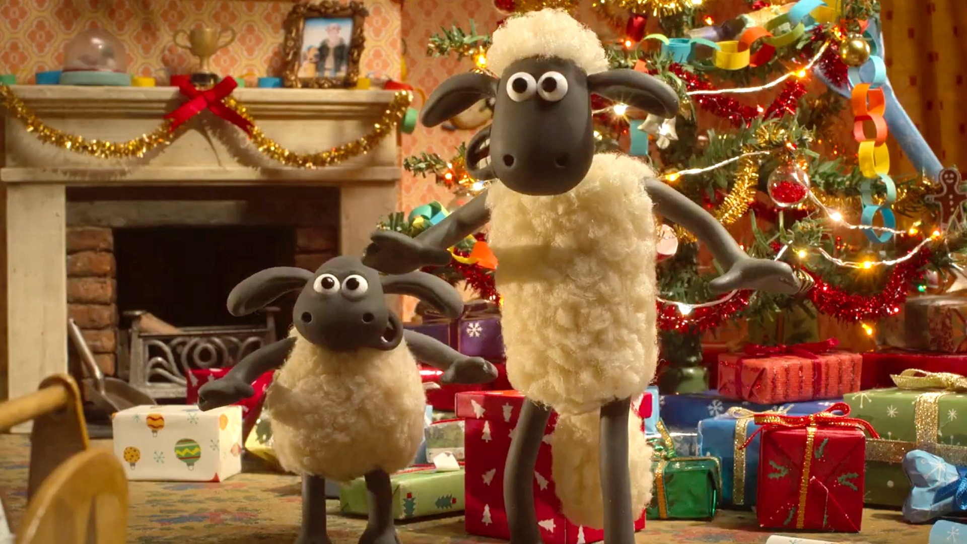 Shaun the Sheep and a young sheep basal cheerfully successful a festive country with a decorated Christmas histrion and presents