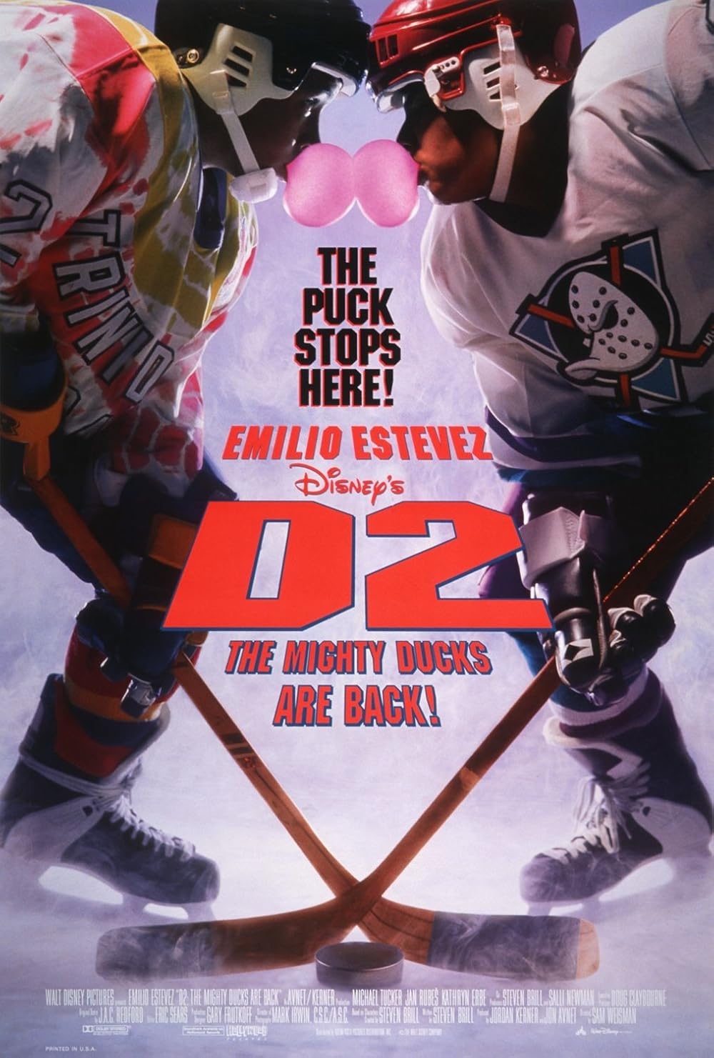 Two hockey players face off with sticks crossed. Text: "The Puck Stops Here! Emilio Estevez, Disney's D2 The Mighty Ducks Are Back!"