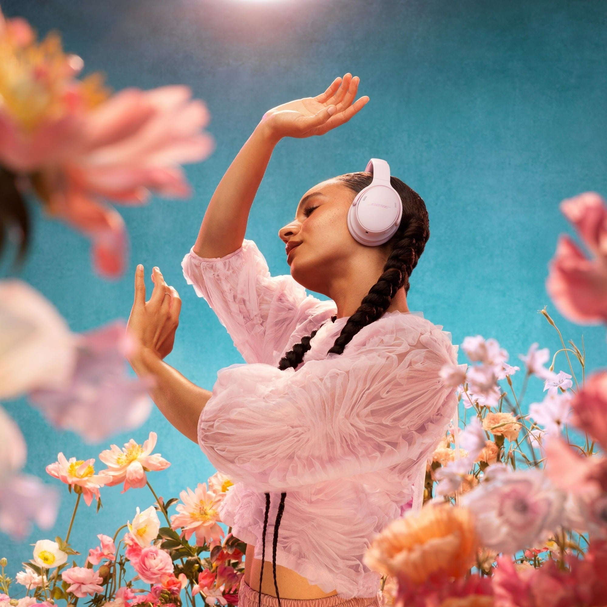 Person wearing headphones, dancing joyfully among blooming flowers, highlighting a serene, immersive euphony  experience