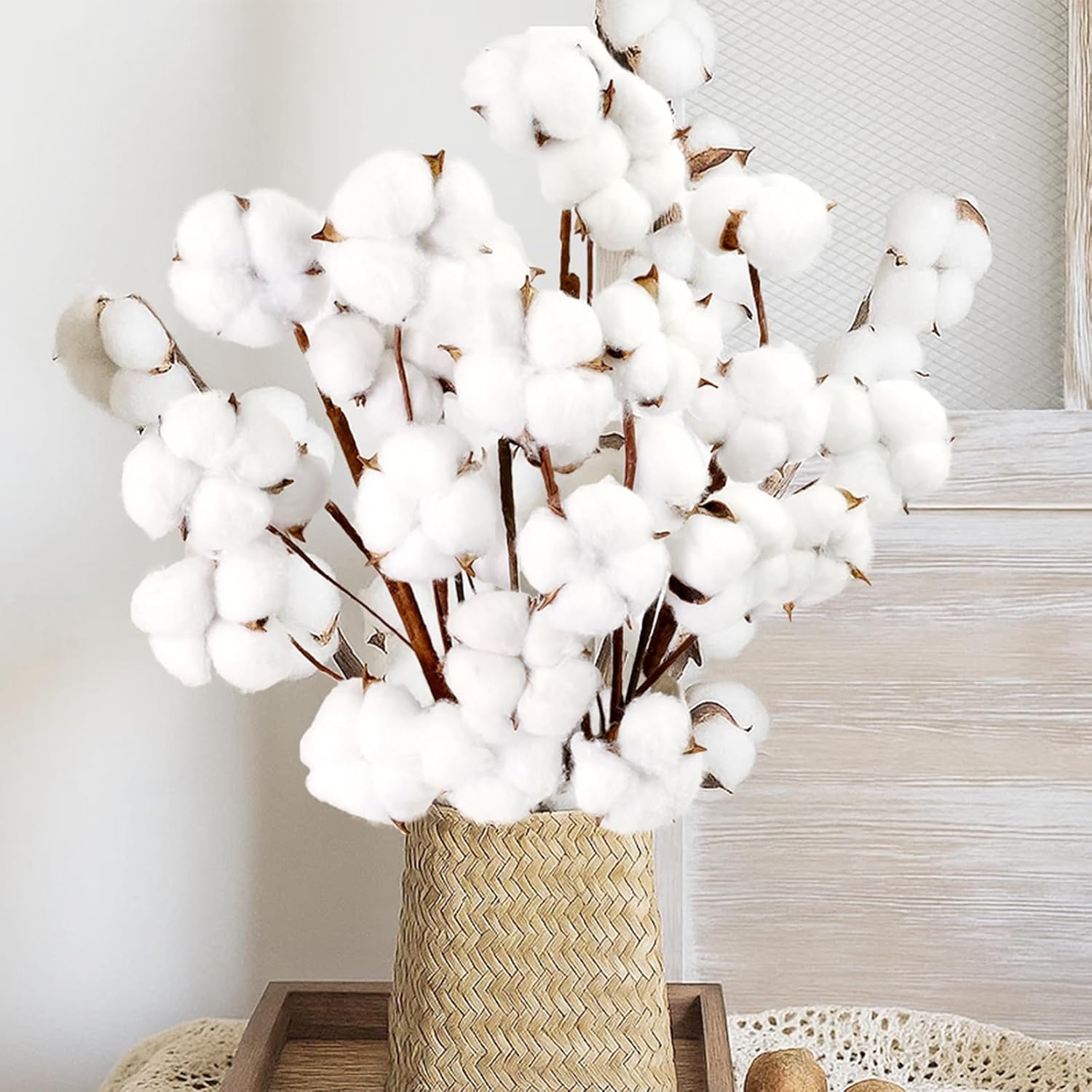 Cotton branches arranged successful  a woven handbasket  connected  a woody  tray