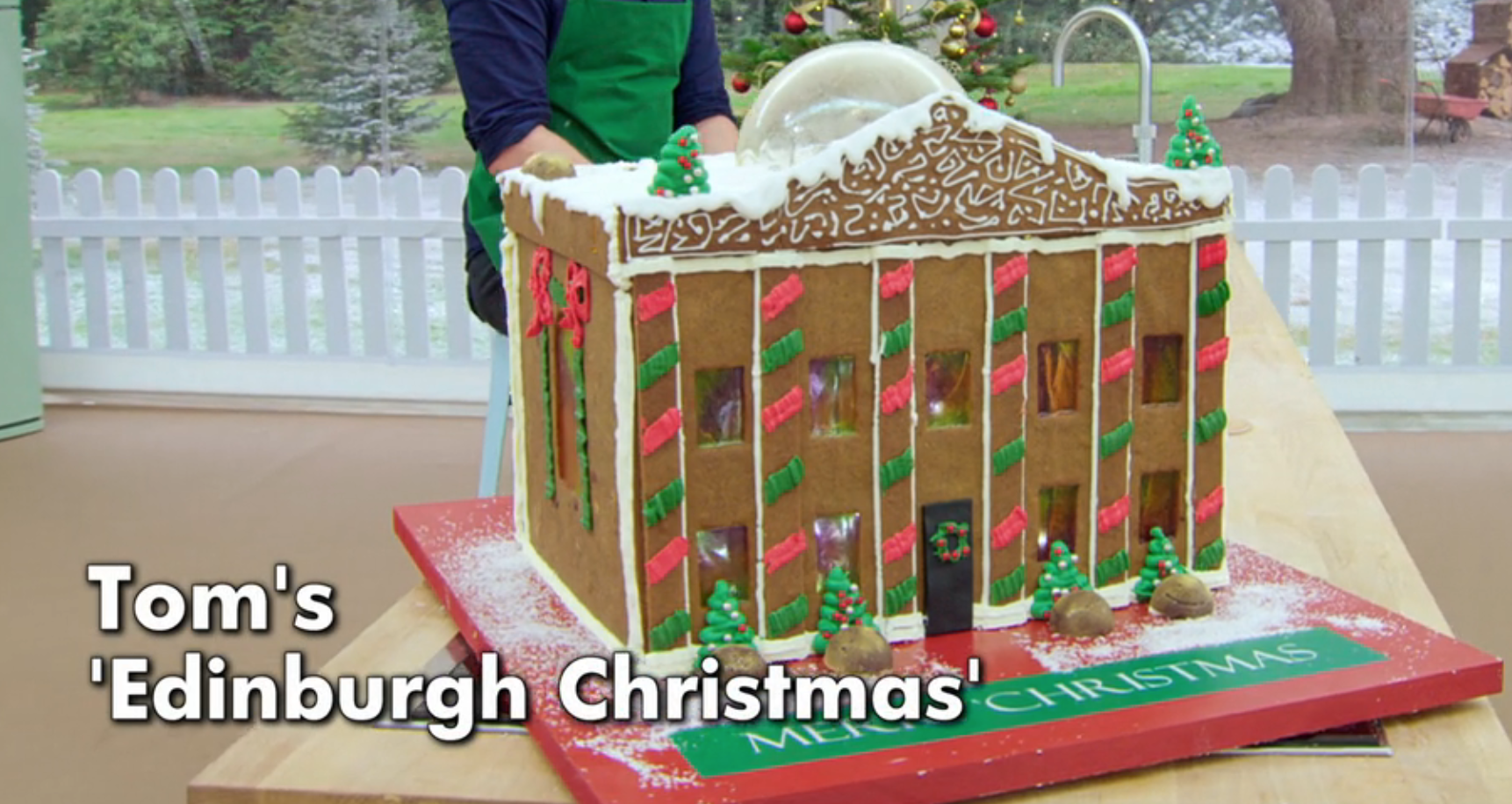 Gingerbread house resembling Edinburgh architecture with festive decorations and snow details, titled "Tom's 'Edinburgh Christmas'"