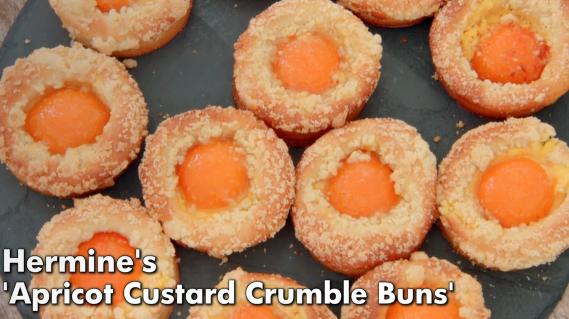 Apricot custard crumble buns with crumbly topping, featuring text: "Hermine's 'Apricot Custard Crumble Buns'."