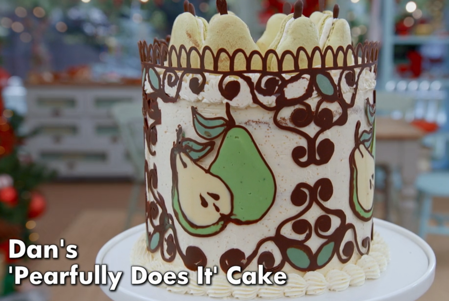 Decorative cake with pear designs and chocolate patterns; labeled "Dan's 'Pearfully Does It' Cake."