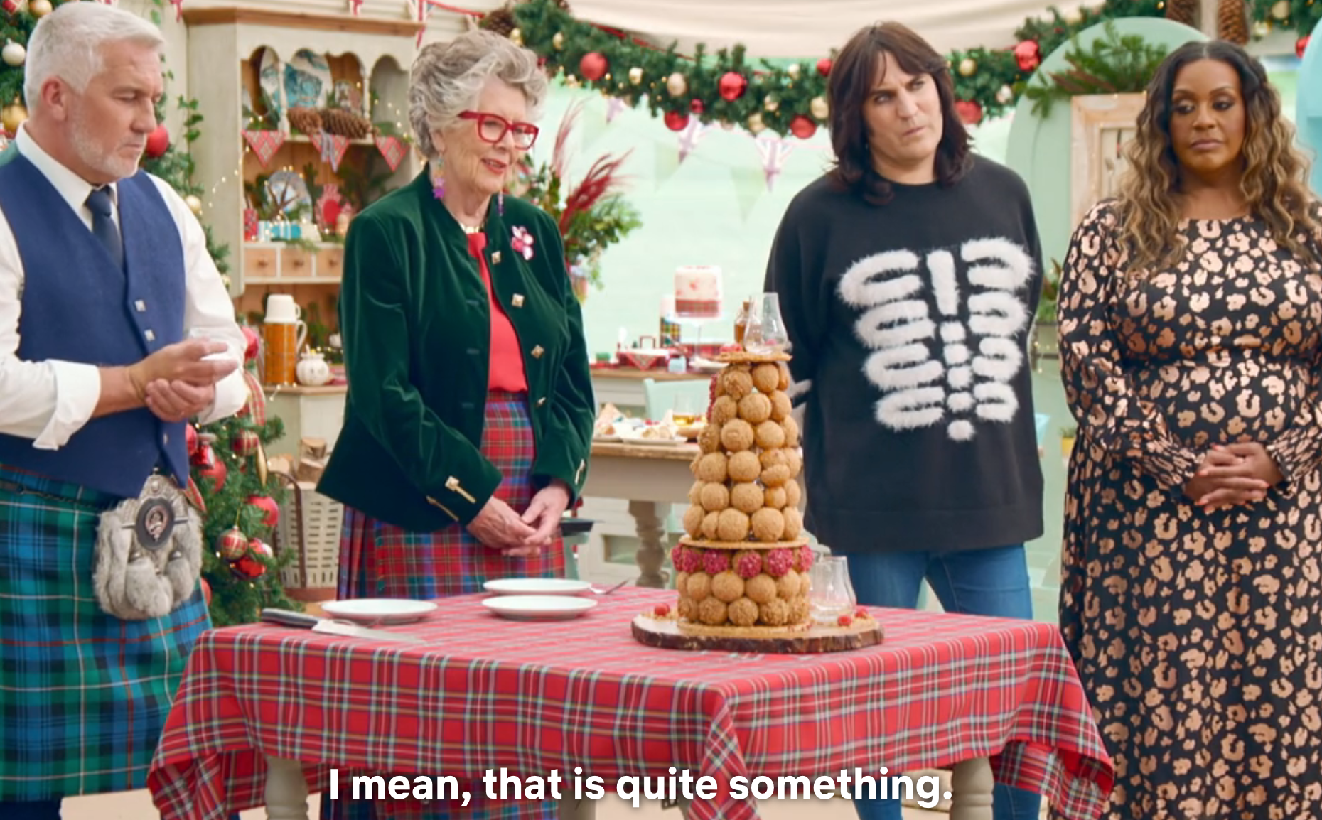 Four radical   basal   astir   a array  with a croquembouche dessert connected  a plaid tablecloth. The mounting  is festive and decorative