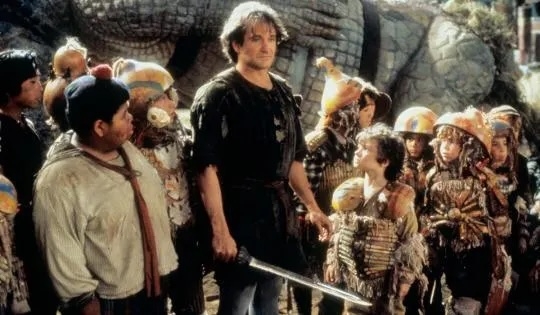 Scene from a phantasy  movie  with a radical  of children surrounding an big  holding a sword, each  dressed successful  adventurous attire