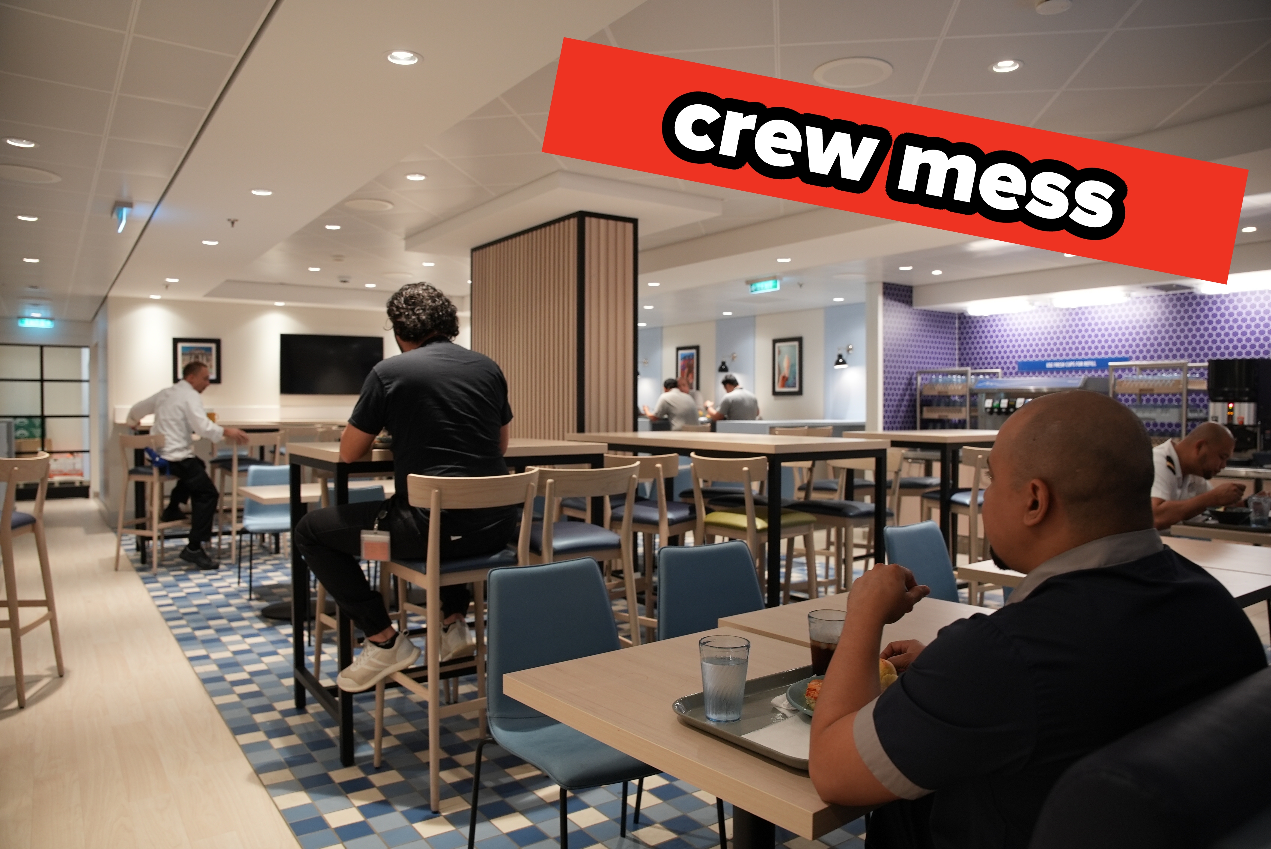 People eating  successful  a modern   cafeteria with bluish  and woody  decor, featuring precocious   and debased  tables