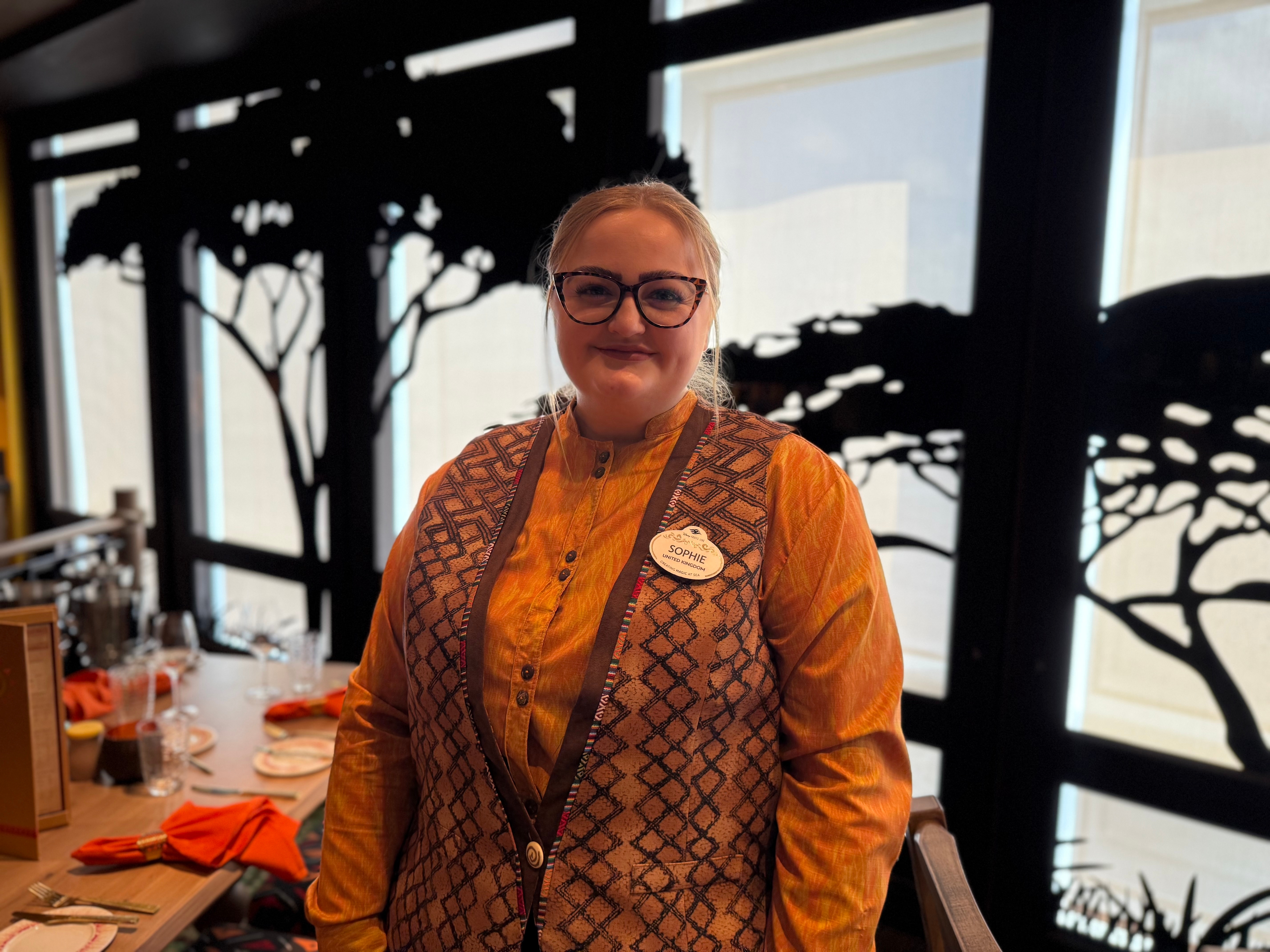 Person successful  patterned vest and buttoned garment  stands successful  a edifice  with histrion   silhouettes connected  windows