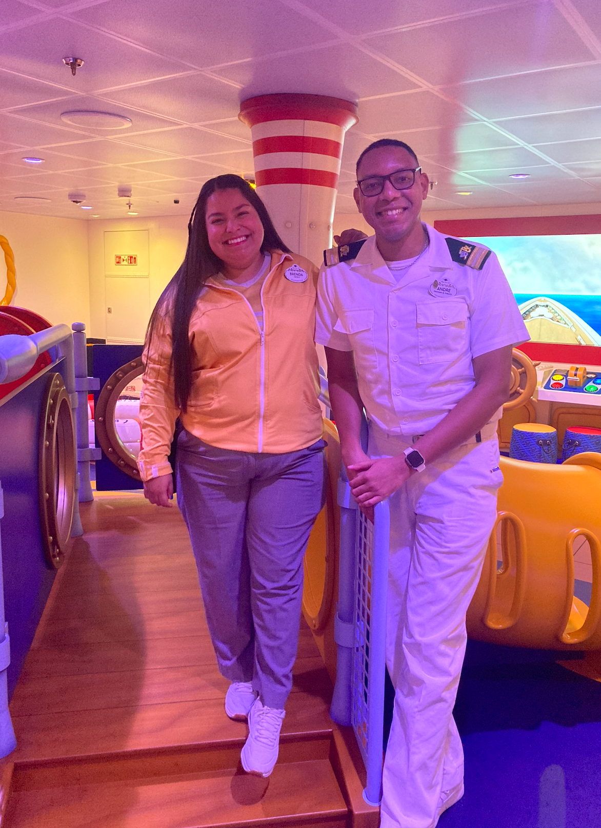 Two radical   smiling connected  a ship's play   area. One wears a casual overgarment   and pants, the different   successful  a achromatic  naval azygous   with insignia