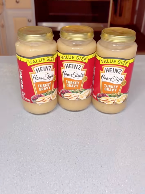 Three jars of Heinz HomeStyle turkey gravy on a countertop