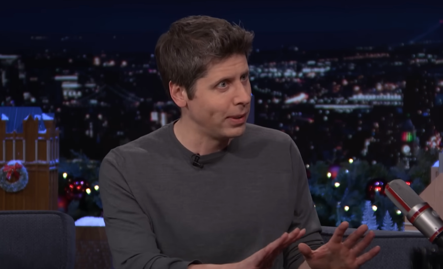 Sam Altman speaking, gesturing with his hands