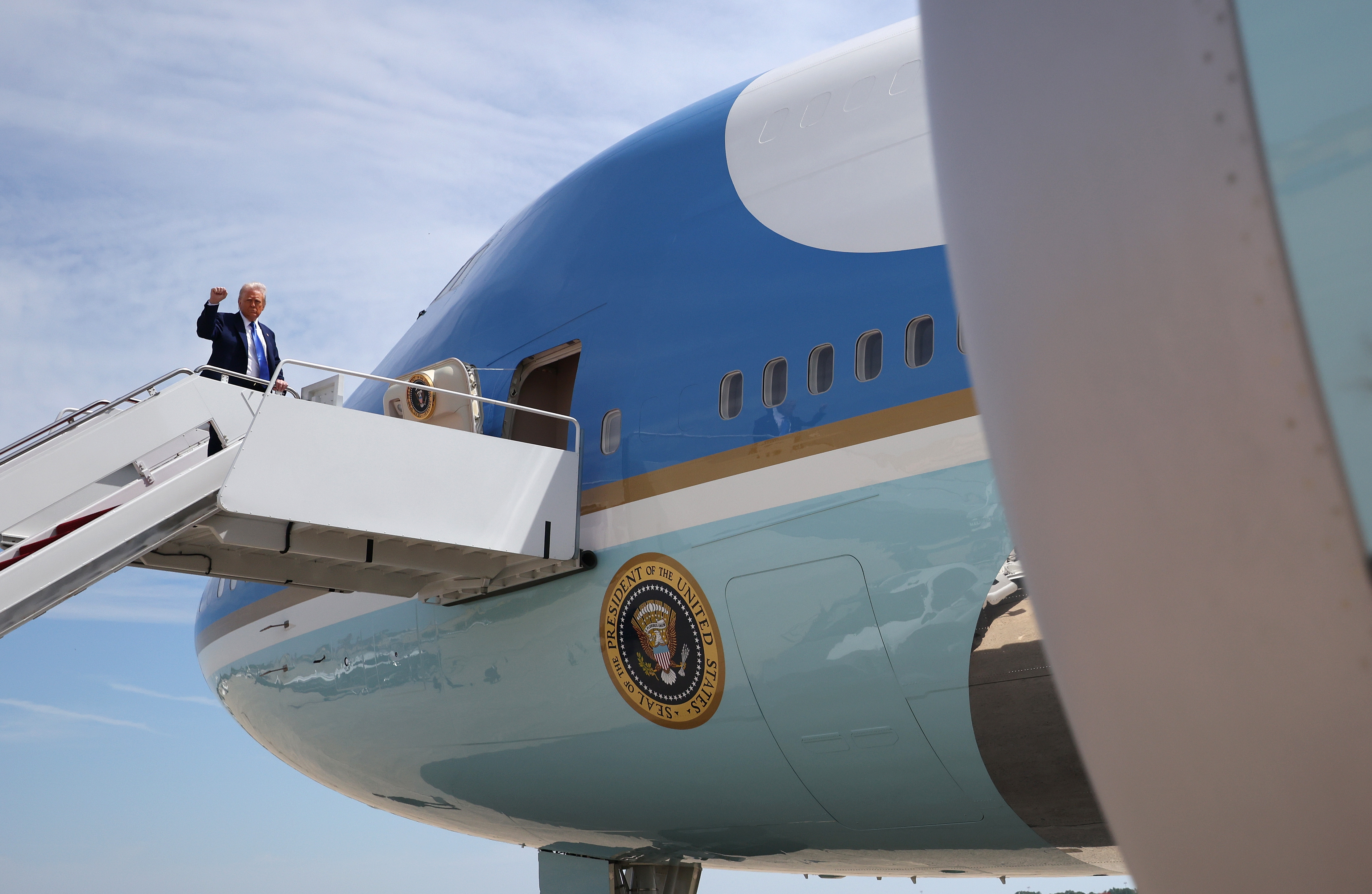 Person waves portion    boarding an authoritative  airplane with the statesmanlike  seal disposable   adjacent   the nose