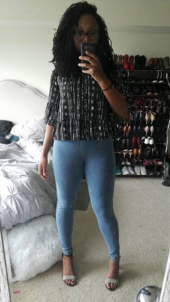 Person wearing a patterned apical and bluish No Nonsense denim leggings taking a reflector selfie