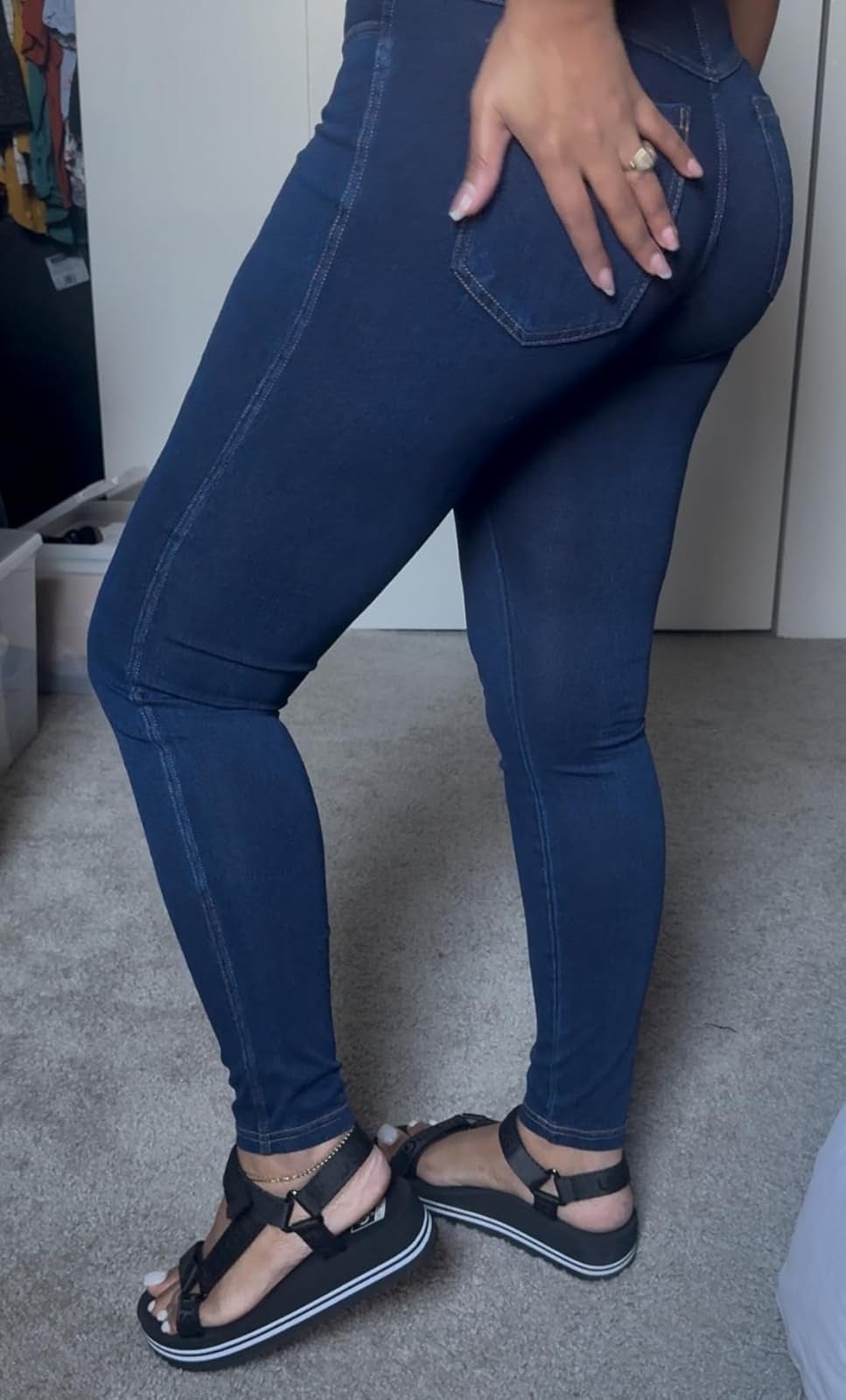 Person modeling No nonsense denim leggings and open-toe sandals from the side